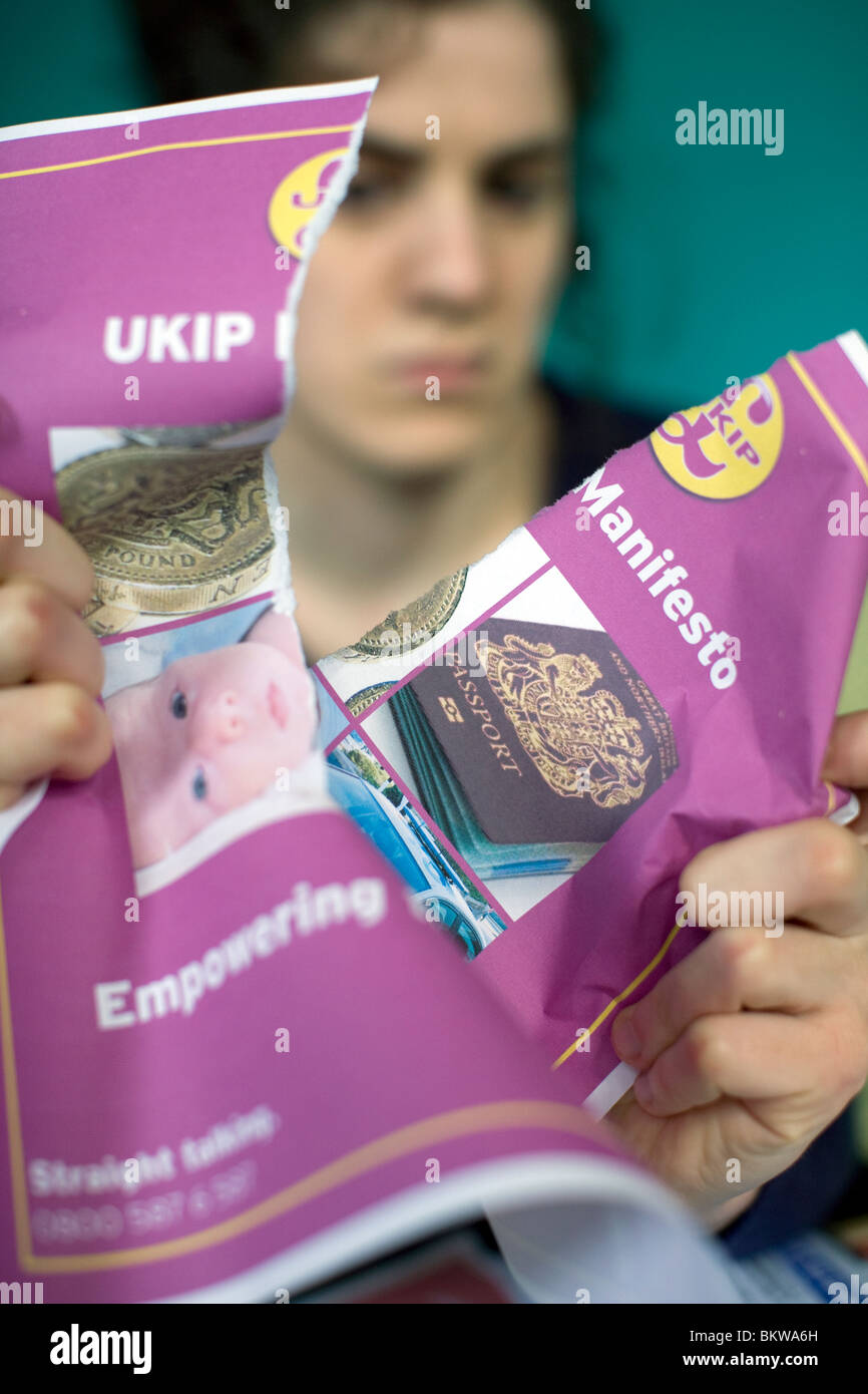 Young person tearing up UKIP manifesto, London Stock Photo