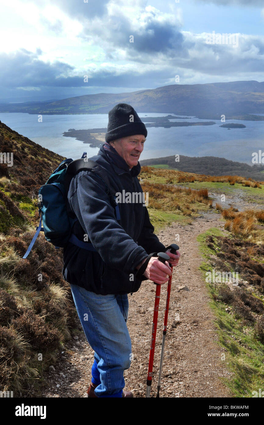 Active elderly people go hill walking in the Trossachs National Park, Scotland Stock Photo