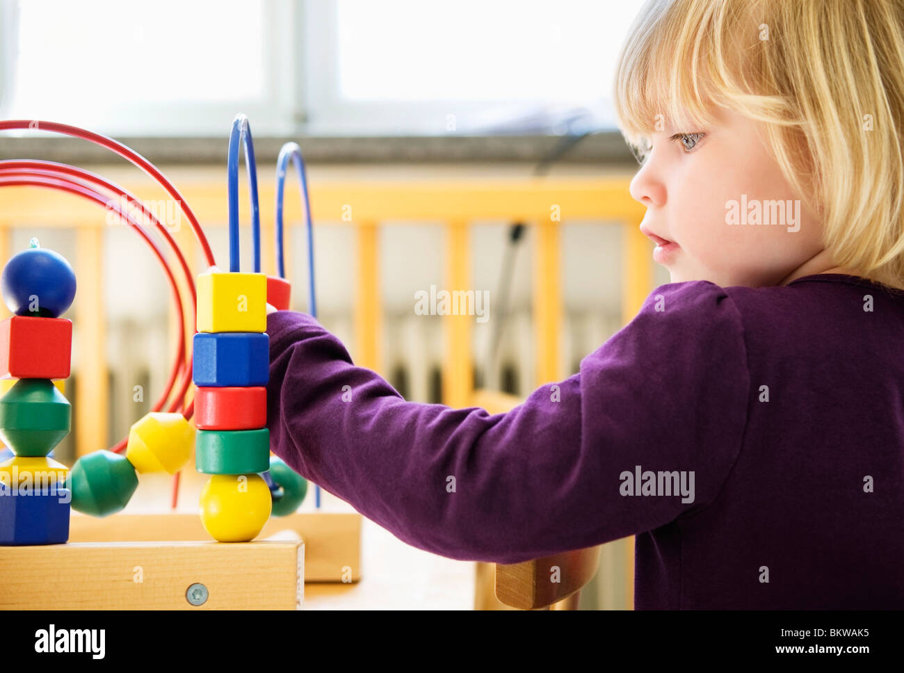 Little girl playing at daycare center Stock Photo