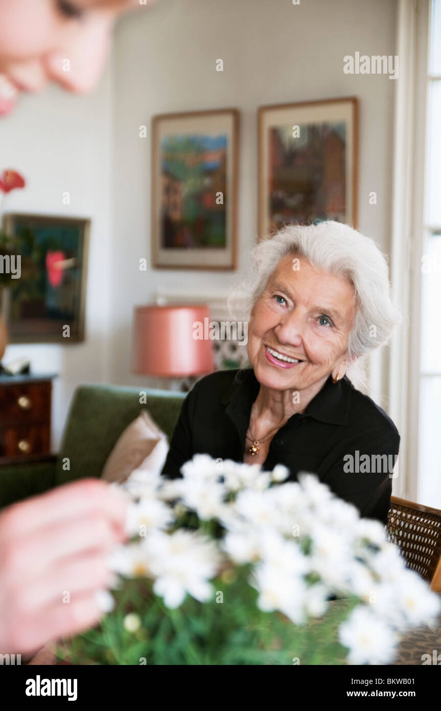 Women in apartment with white flowers Stock Photo Alamy