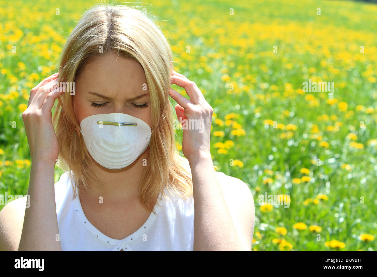 Women with pollen allergy in a Spring Meadow Stock Photo