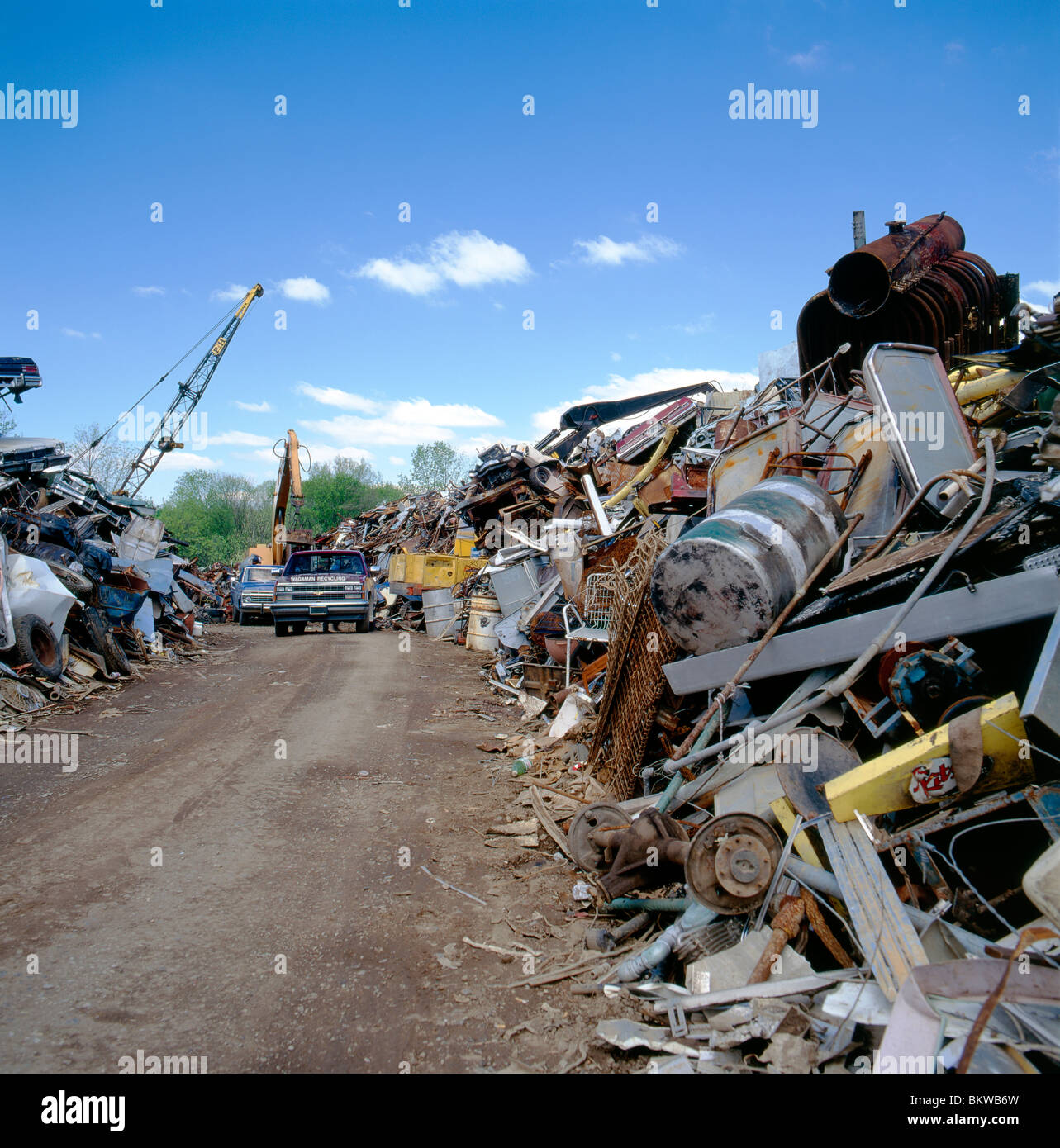 Heavy equipment loading scrap metal into a dump truck at a recycling center Stock Photo Alamy