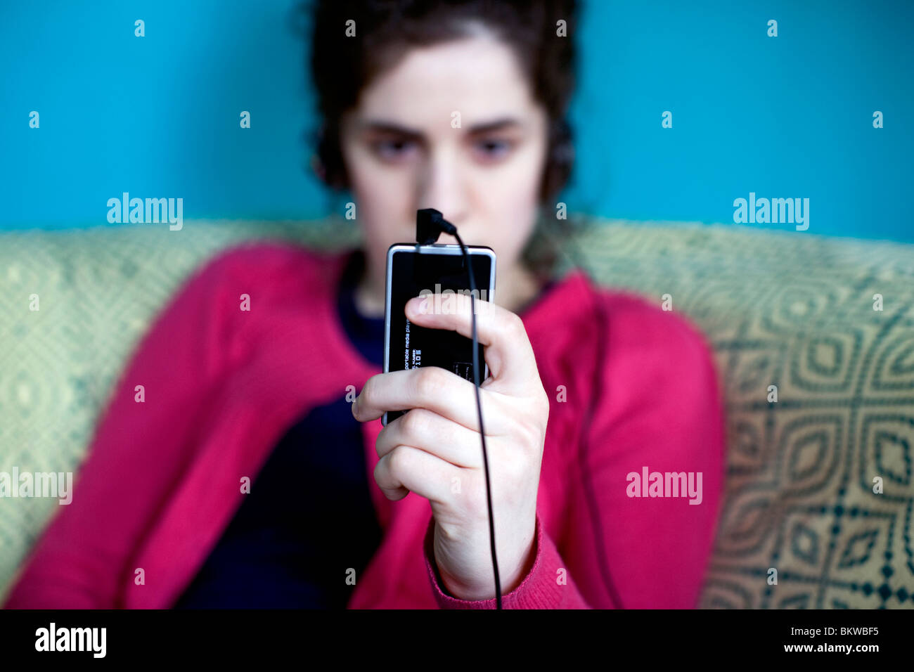 Young woman with MP3 player, London: MODEL RELEASED Stock Photo