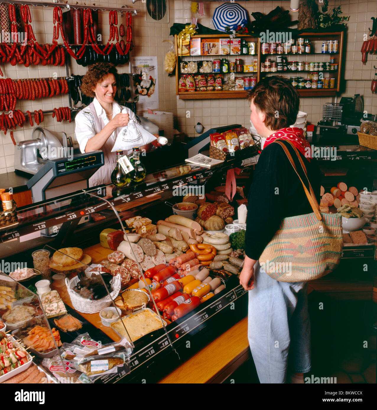 German woman buying meats at a local Metzgerei Truffner ...