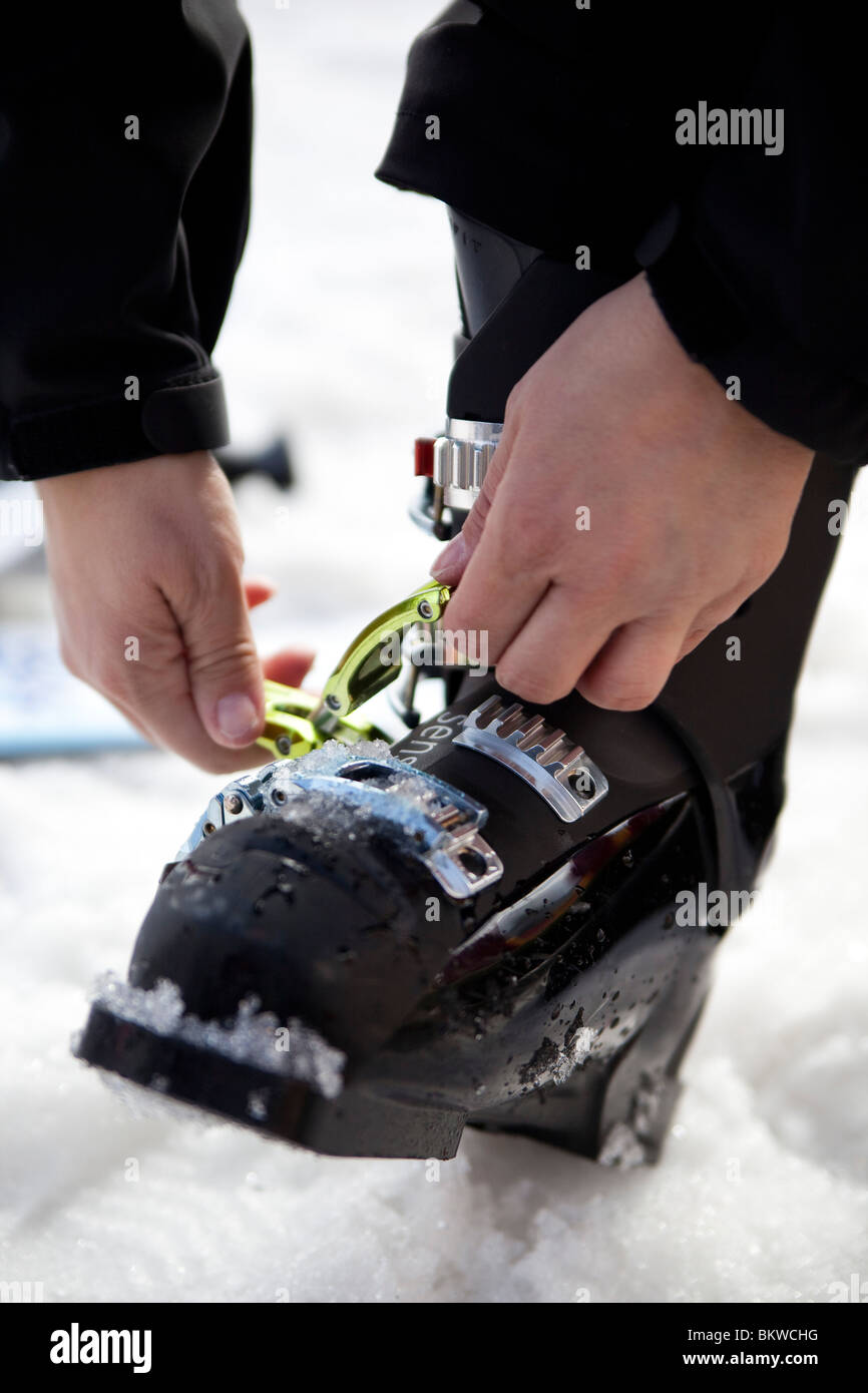 Putting on ski boot Stock Photo Alamy