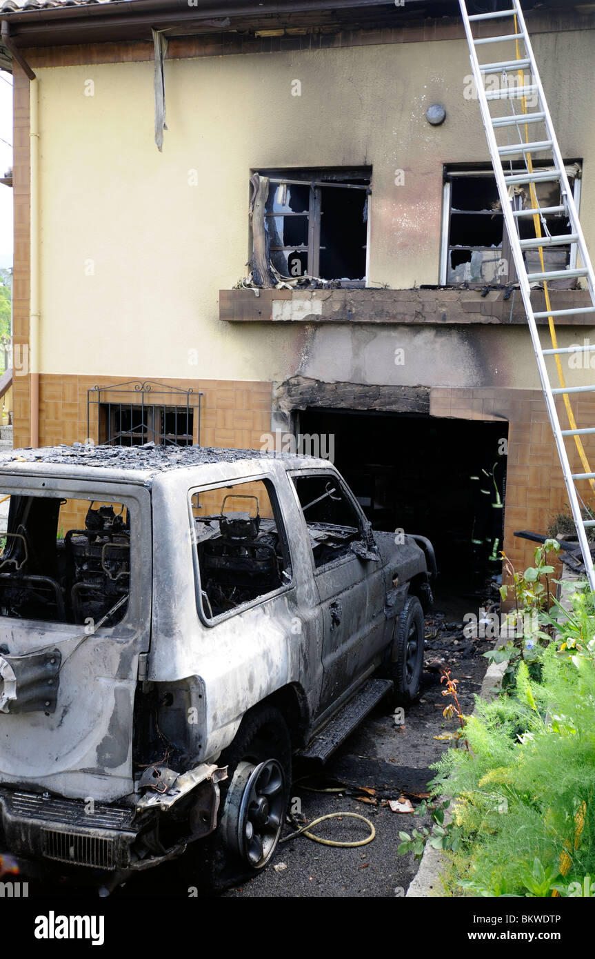 A burnt house and car after firemen team put out the fire, Asturias, Spain Stock Photo