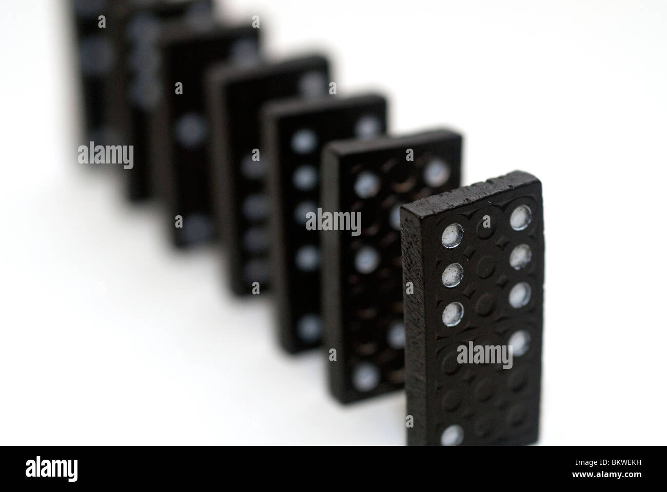 Black Dominoes game block in a row on a colored background Stock Photo -  Alamy