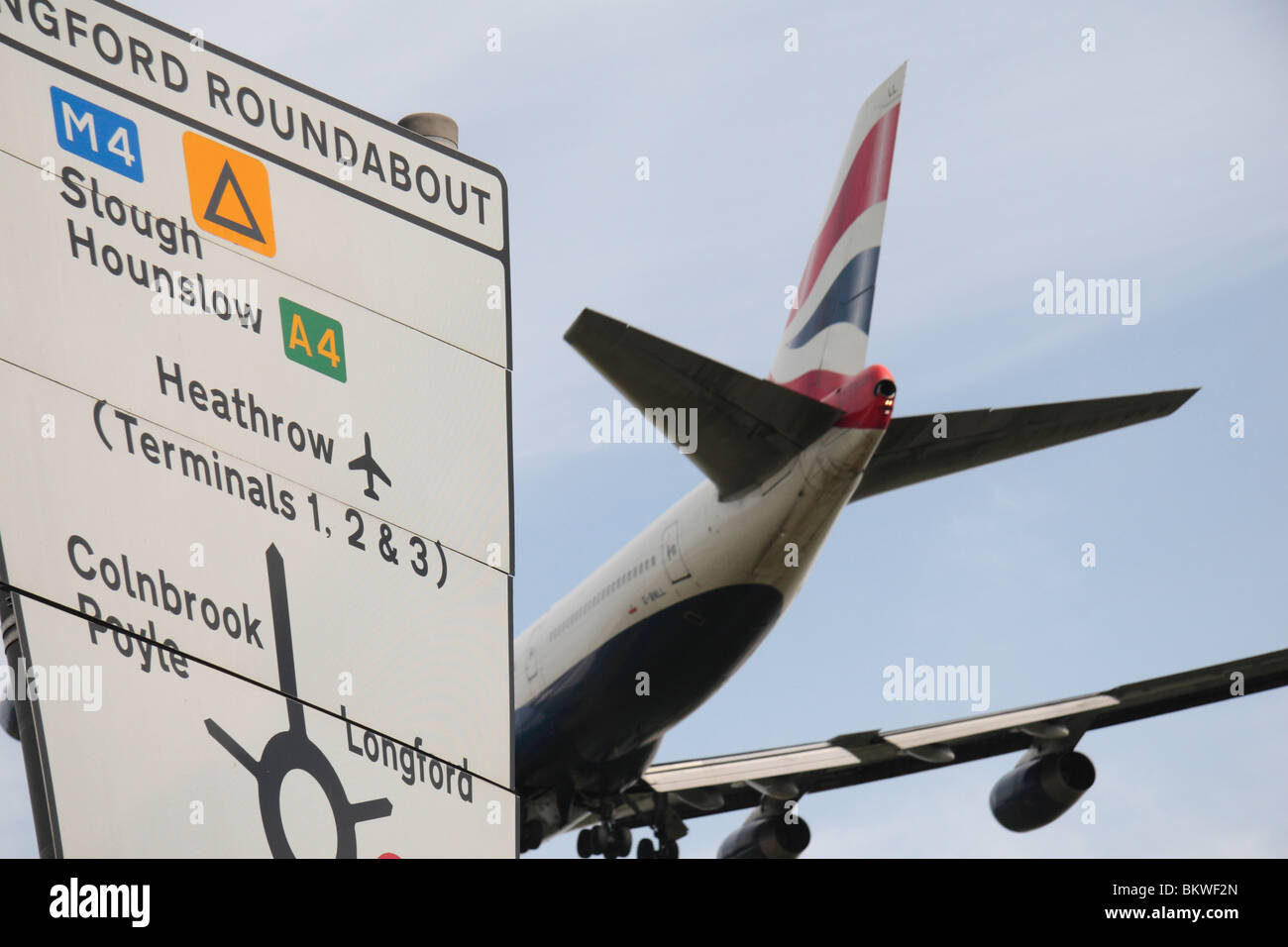 A British Airways 747 passing a road sign while landing at Heathrow Airport, London, UK. Stock Photo