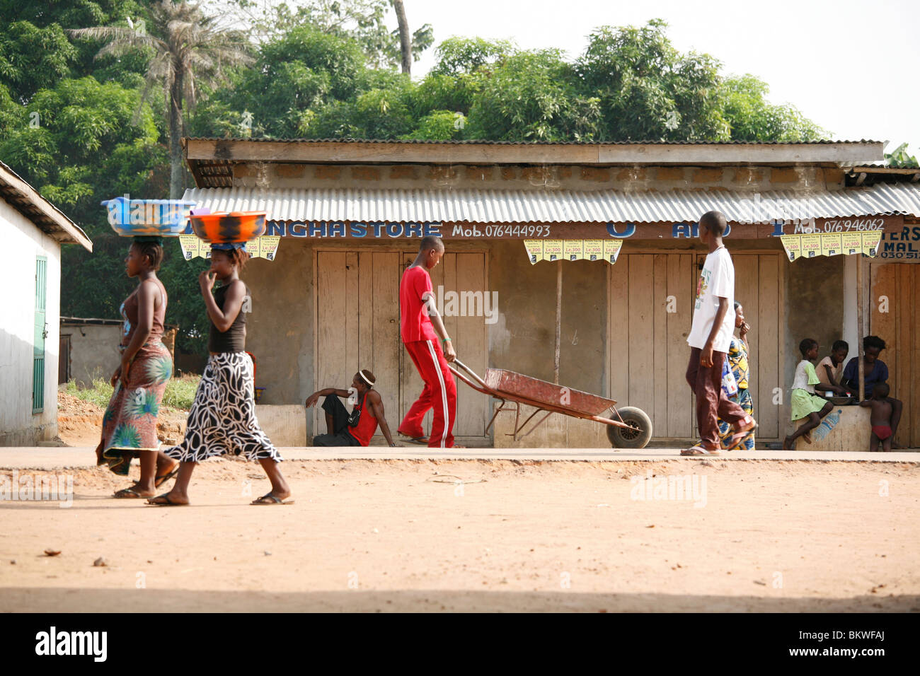 Women going to and from market with produce, Rotifunk-Lungi village, Sierra Leone, West Africa Stock Photo