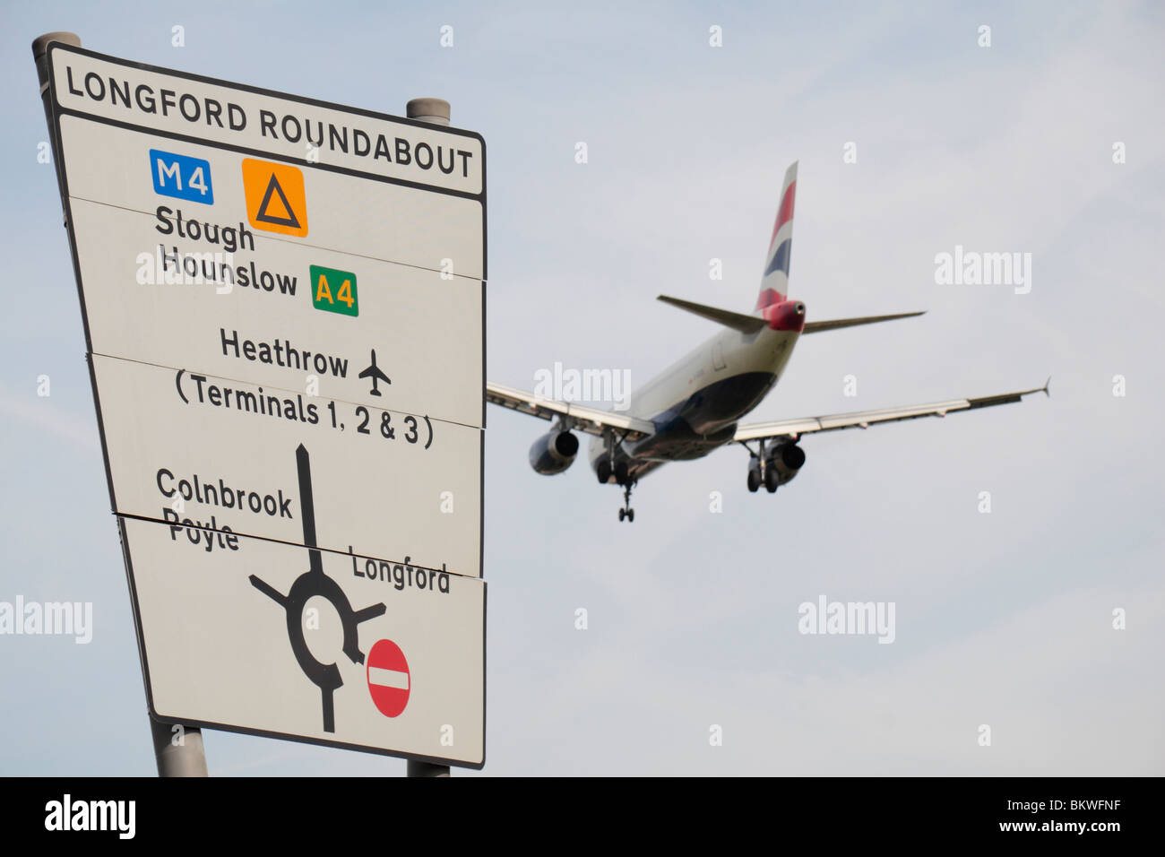 A British Airways 747 passing a road sign while landing at Heathrow Airport, London, UK. Stock Photo