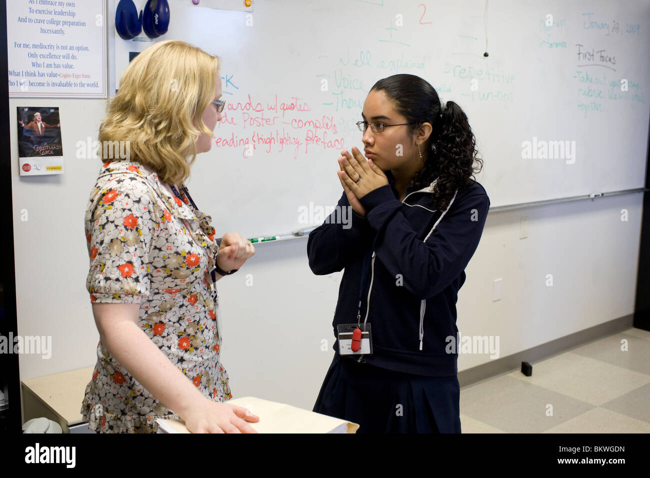 Teacher talks to high school student after class at charter school Peak Preparatory Academy in Dallas, Texas, USA Stock Photo