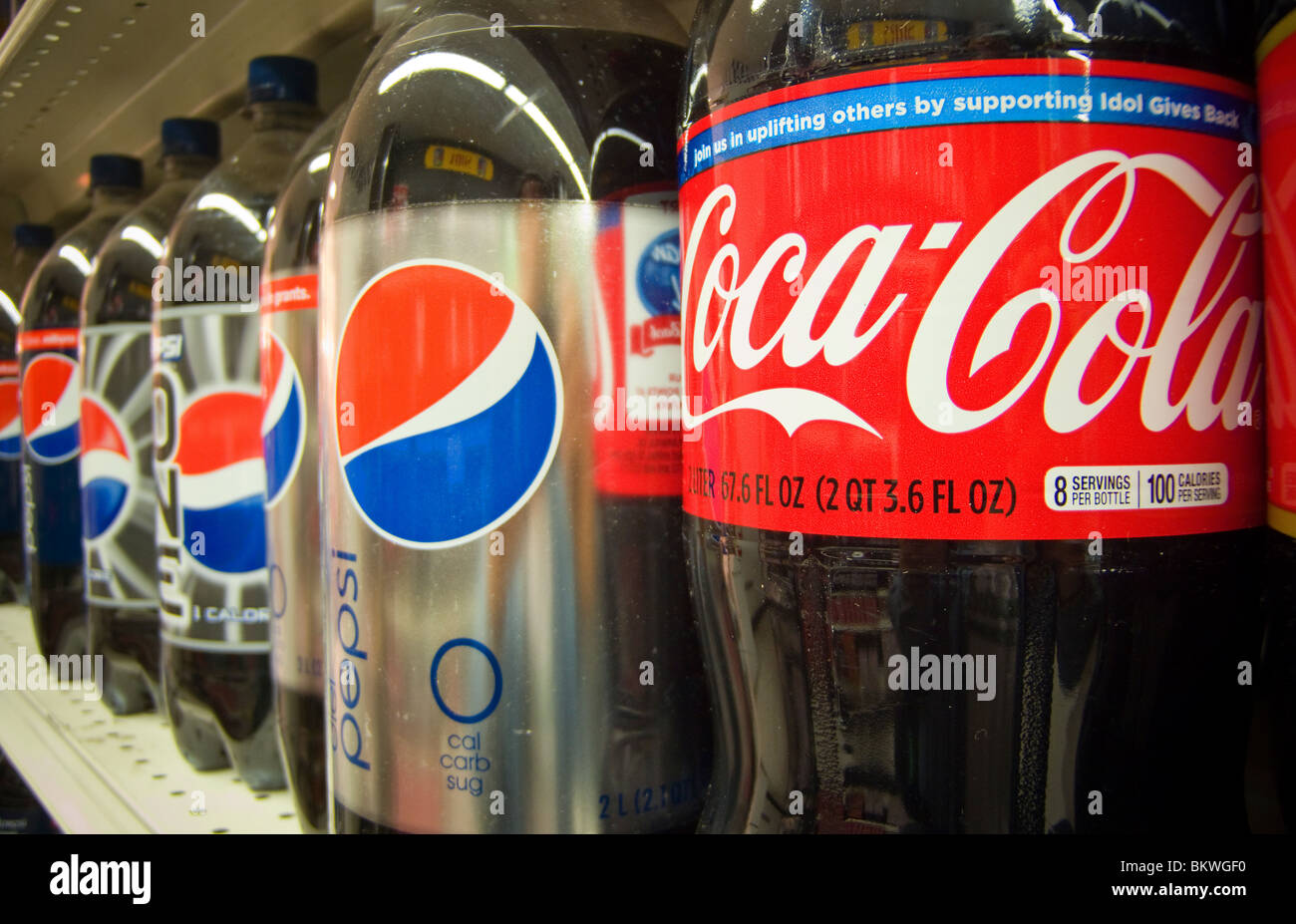 Bottles of Pepsi-Cola and Coca-Cola on a supermarket shelf in New York Stock Photo