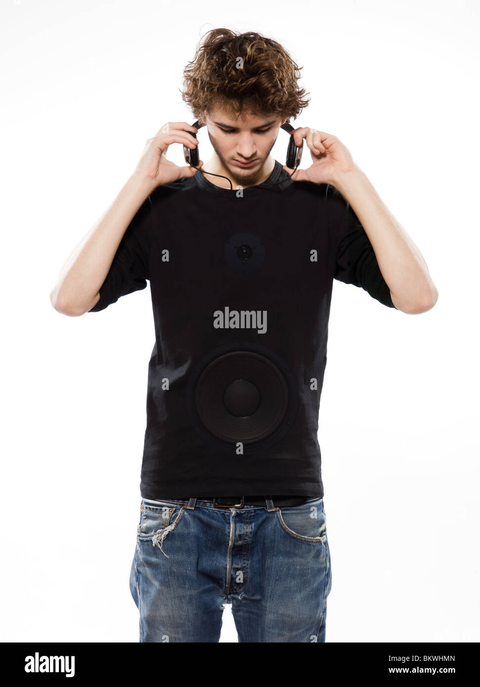 studio portrait of a caucasian young man listening to music on white background Stock Photo