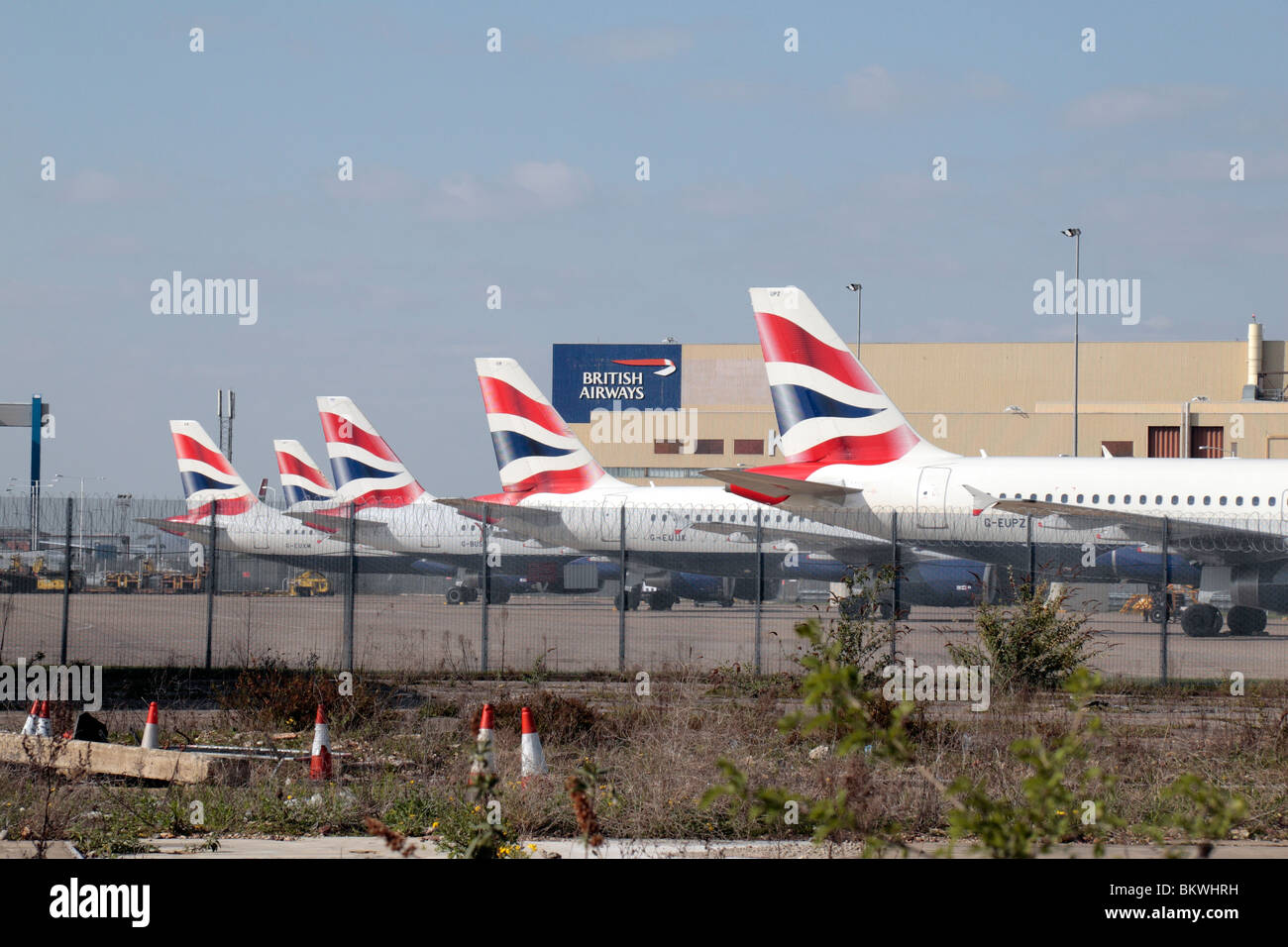 A line of British Airways planes parked close to the southern perimeter waste ground of Heathrow Airport. Apr 2010 Stock Photo