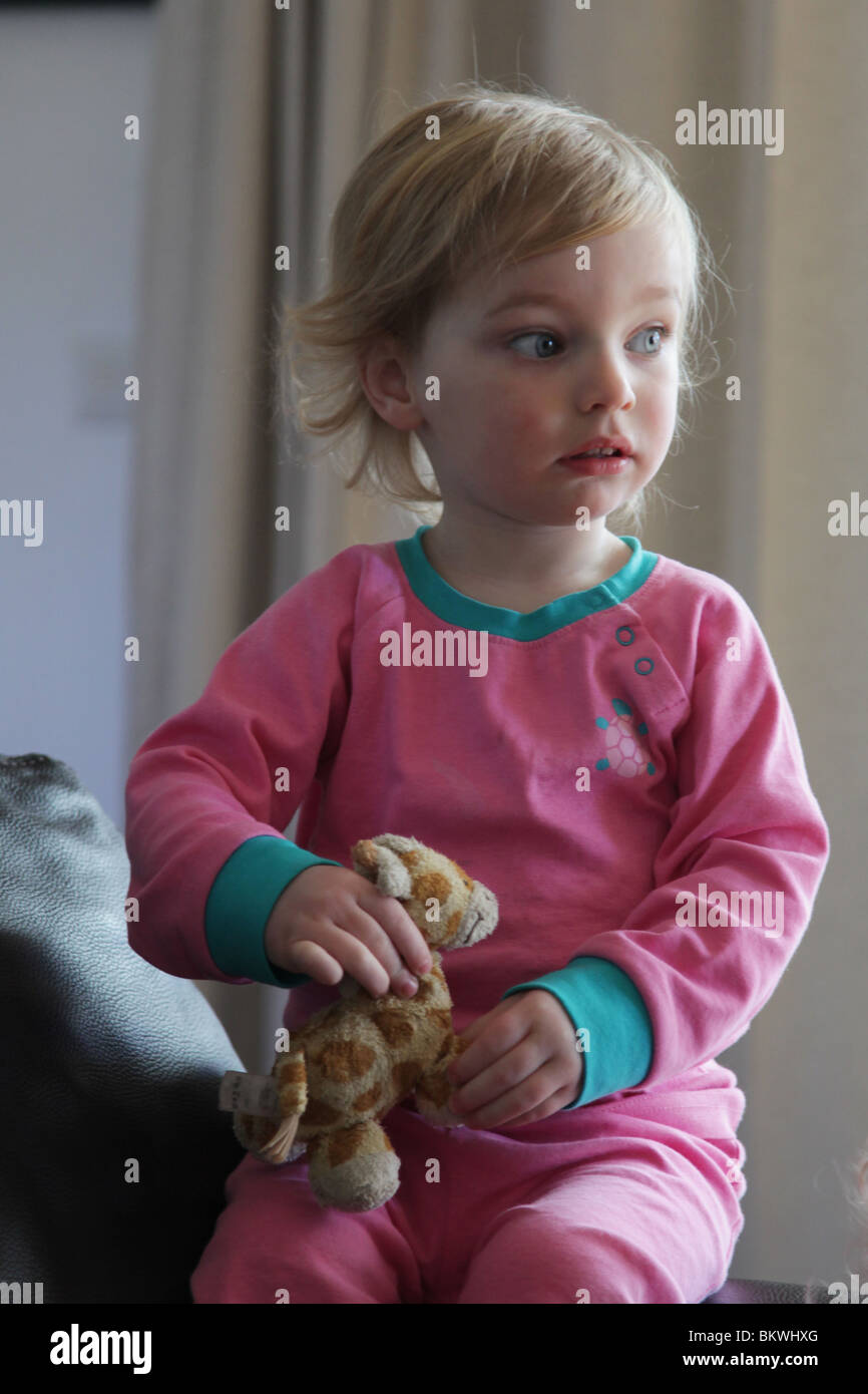 two year old child baby girl sit sitting sat sofa couch soft toy hold