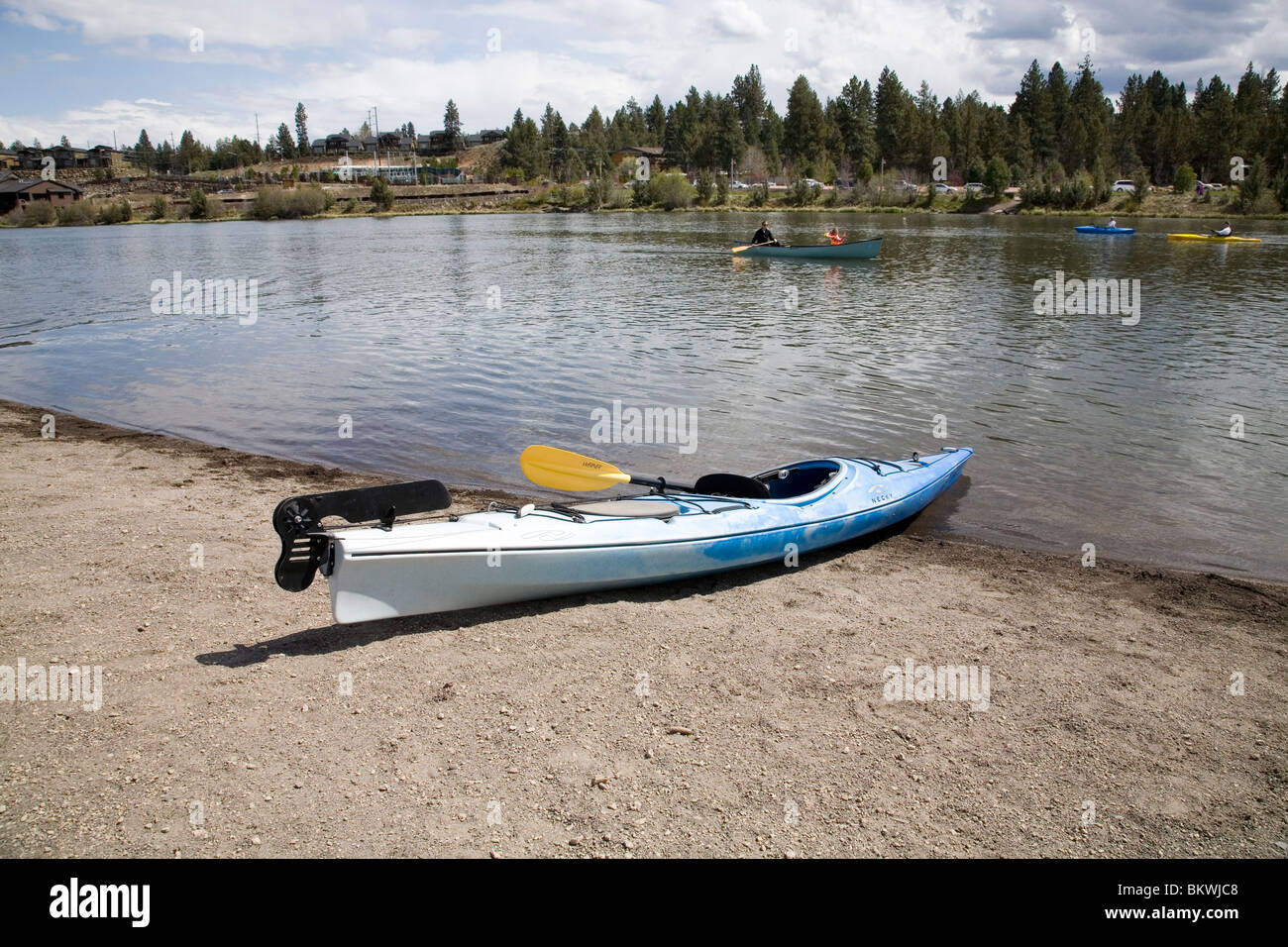 A kayak on a sandy beach on the Deschutes River in Bend, Oregon Stock Photo