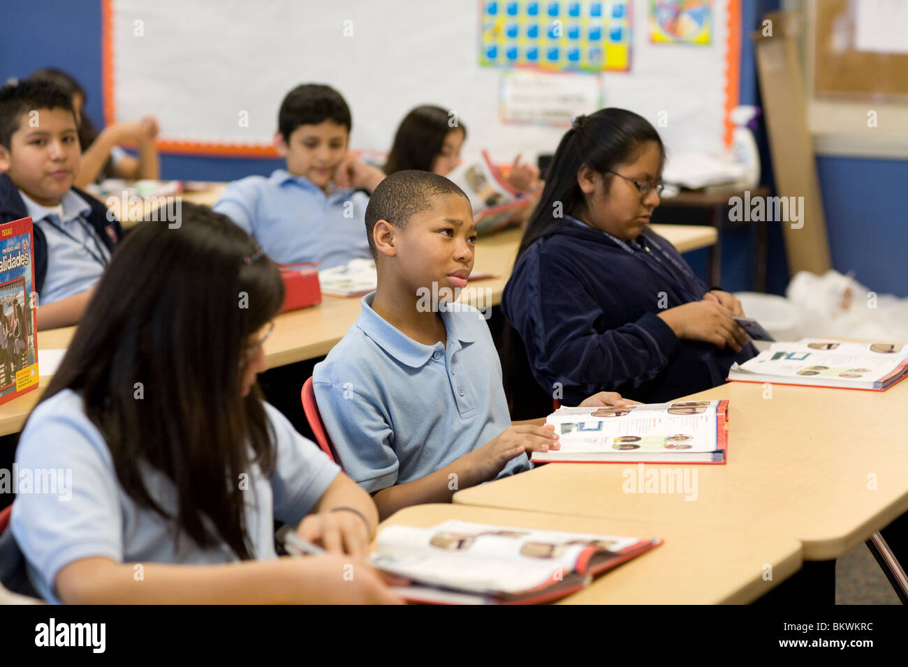African-American middle school boy listens in his classroom at charter school Peak Preparatory Academy in Dallas, Texas, USA Stock Photo