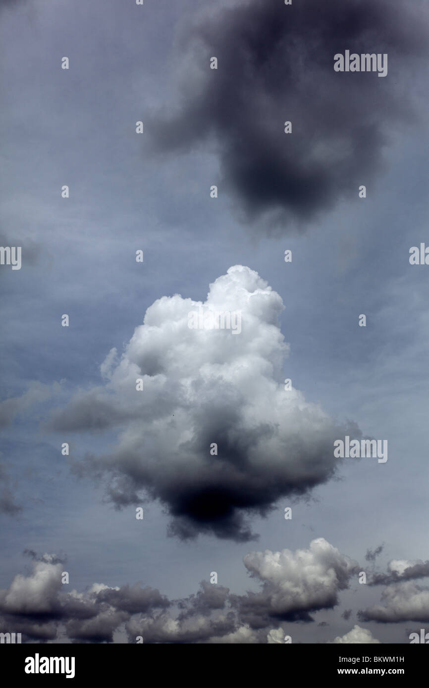 Lone small cumulus cloud in hazy sky. Stock Photo