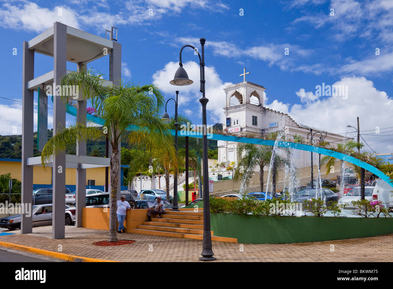 The town square in Yabucoa, Puerto Rico with decorative water fountain and church. Stock Photo