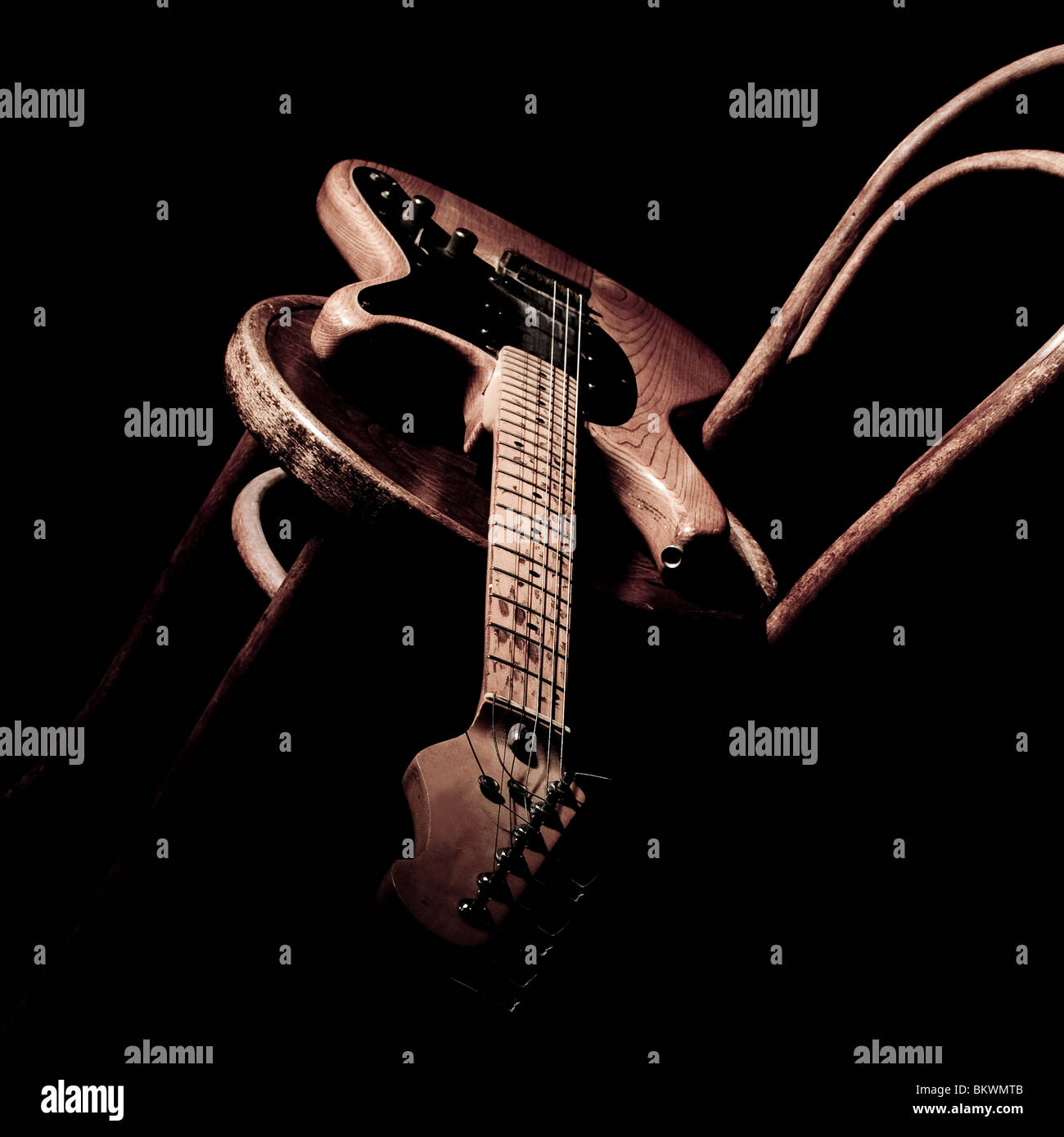 Electric guitar on wooden chair Stock Photo Alamy