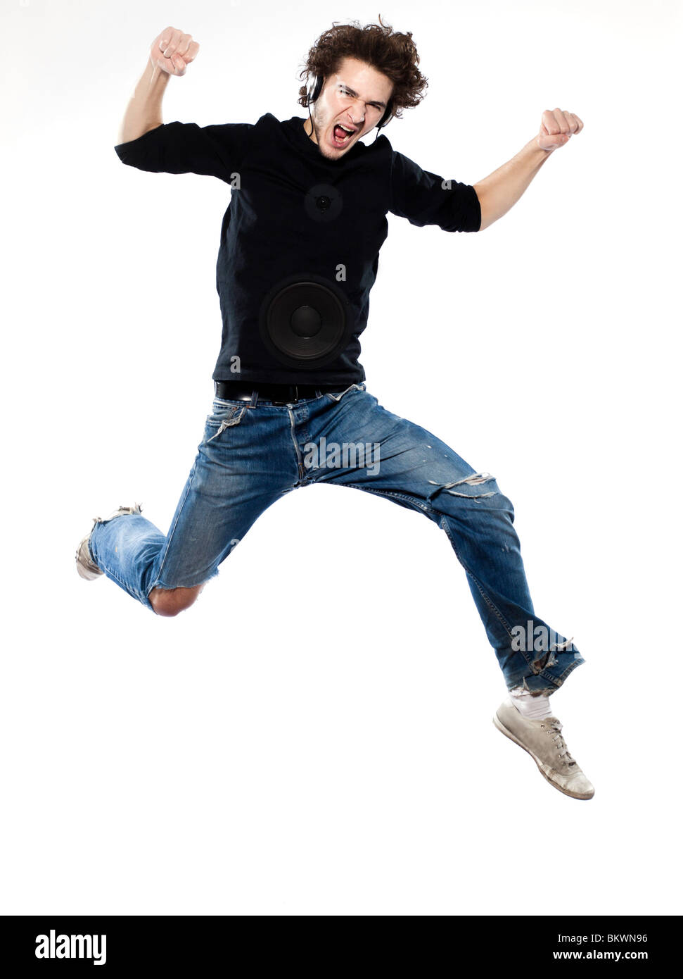 studio portrait of one  caucasian young man listening to music music jumping screaming isolated on white background Stock Photo