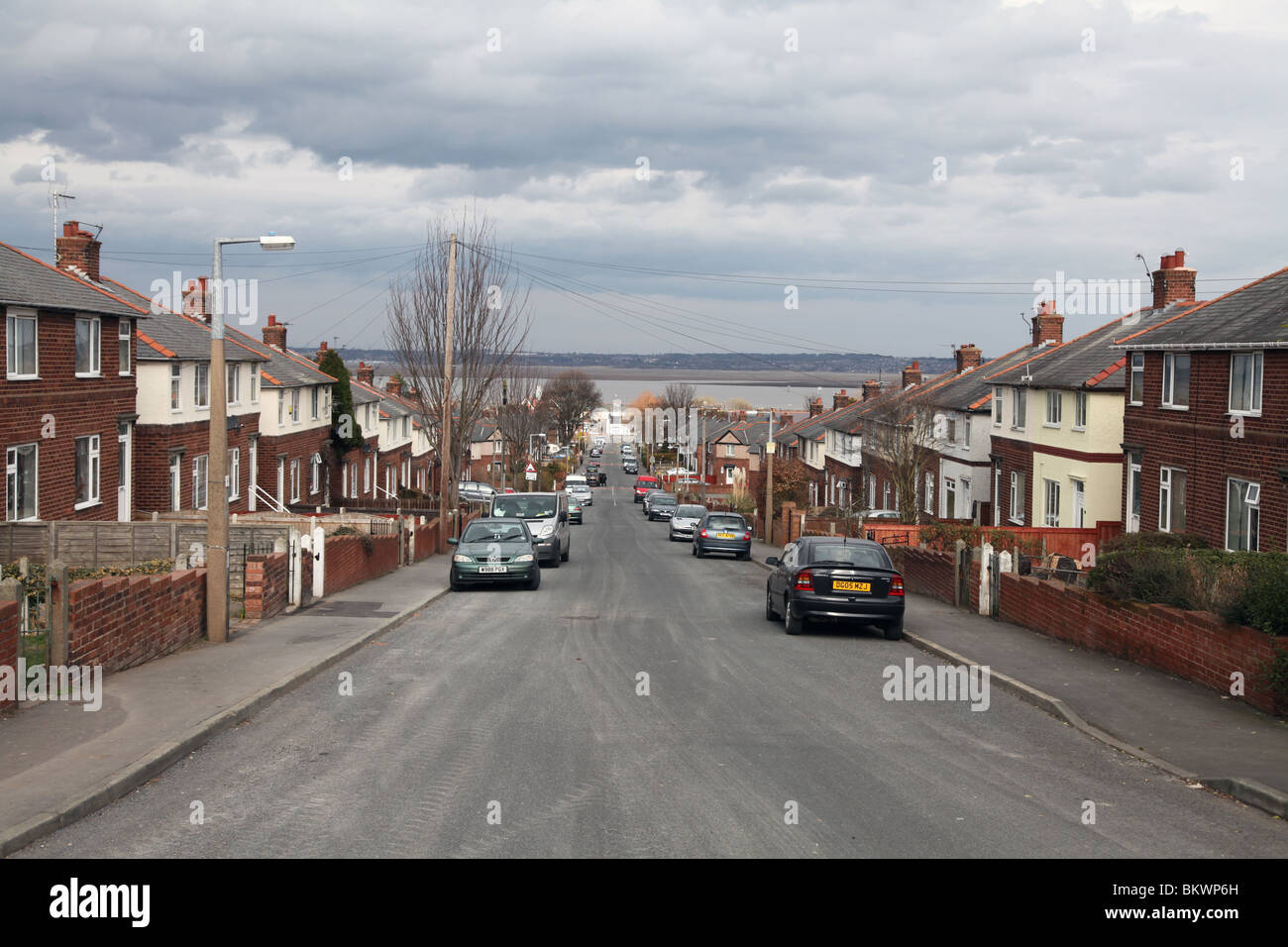 Council housing estate overlooking Dee Estuary in Flint, north Wales to Wirral in distance Stock Photo