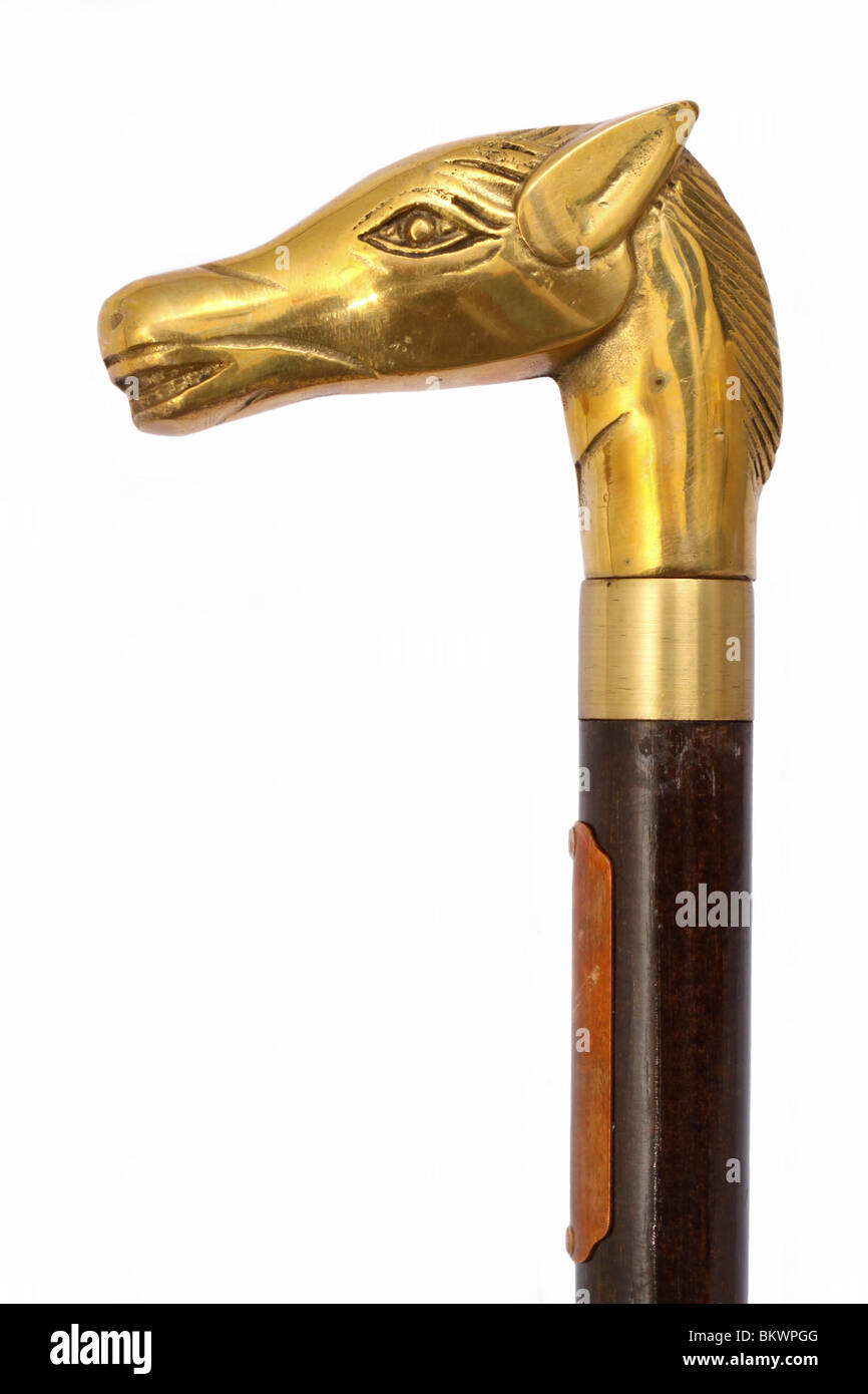 Close-up of antique wooden walking stick with solid brass horse head handle, isolated on white background Stock Photo