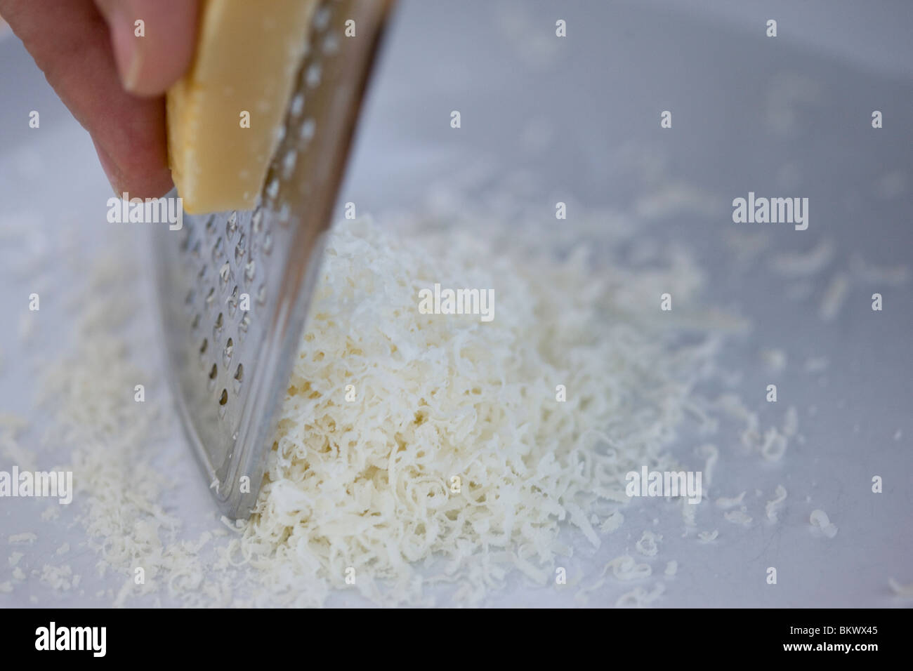 Grating parmesan cheese Stock Photo Alamy