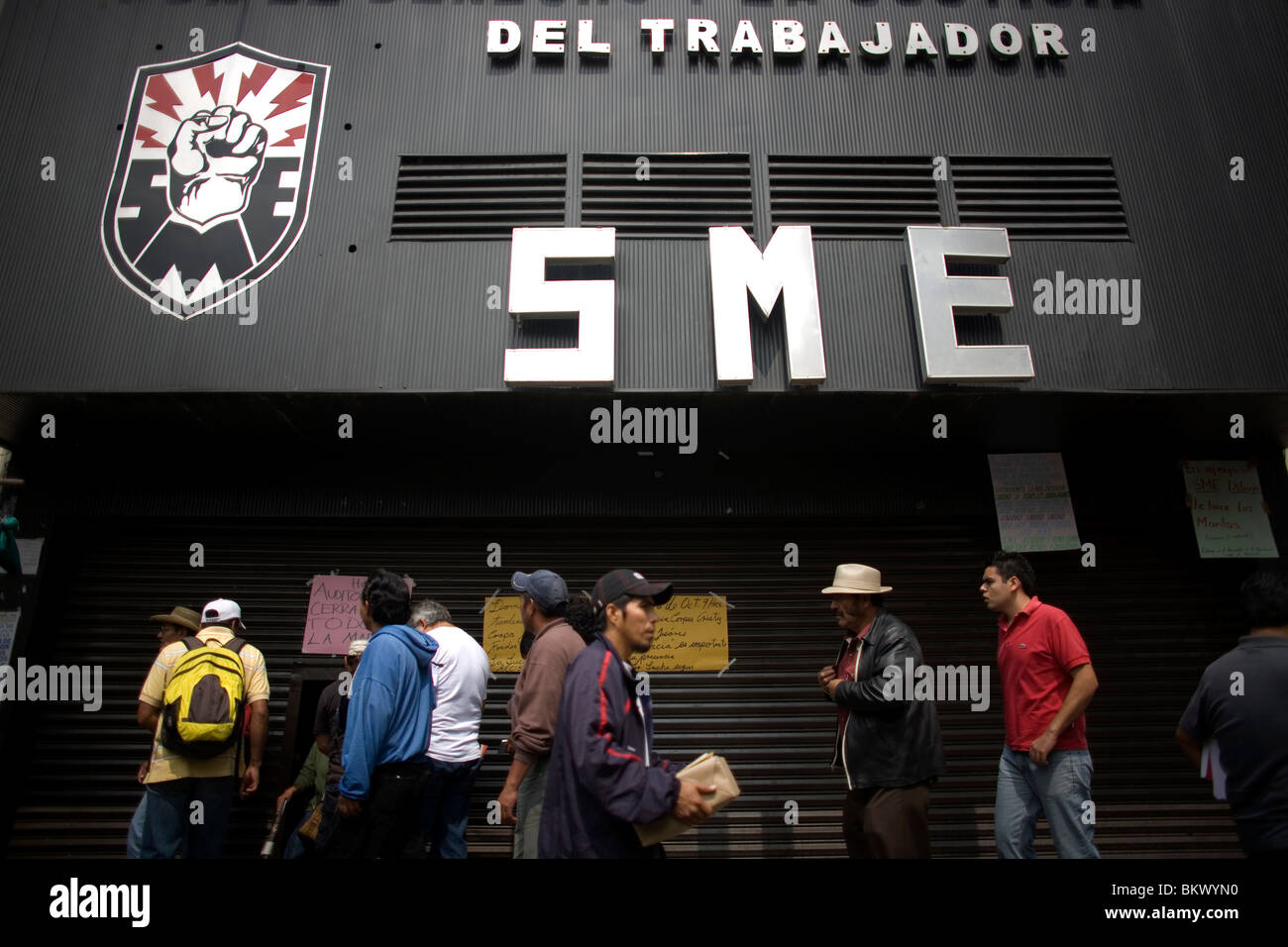 People walk outside of the headquarters of Mexico's electricity union (SME) in Mexico City, October 23, 2009. Stock Photo