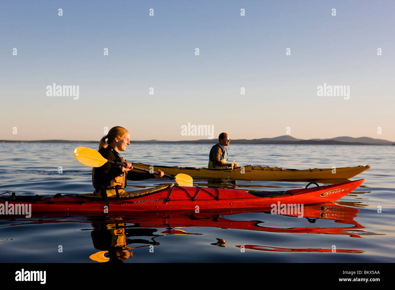 A man and woman sea kayaking near Sheep Porcupine Island in Maine's