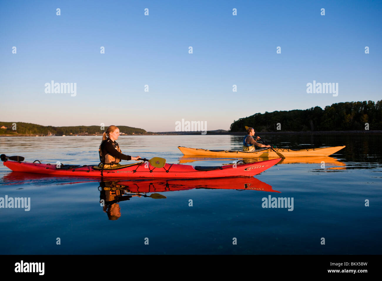 A man and woman sea kayaking near Sheep Porcupine Island in Maine's