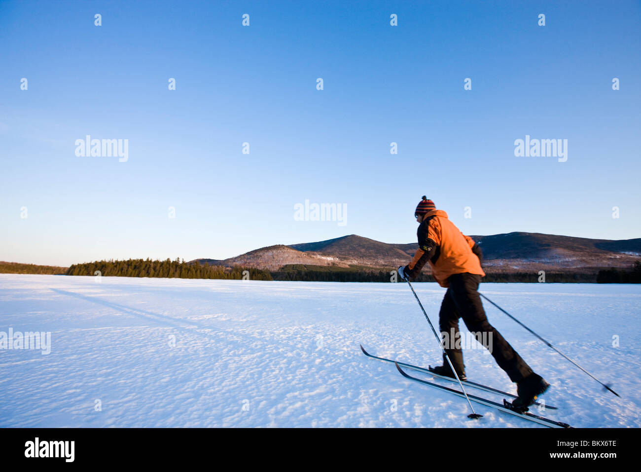 A man crosscountry skis on First West Branch Pond at West Branch Pond