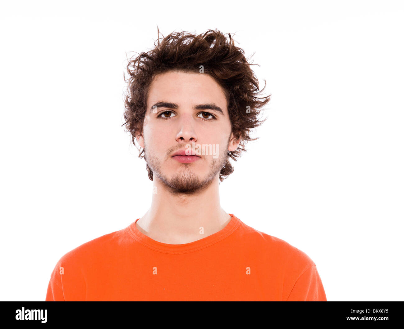 young serious caucasian man portrait in studio on white background Stock Photo