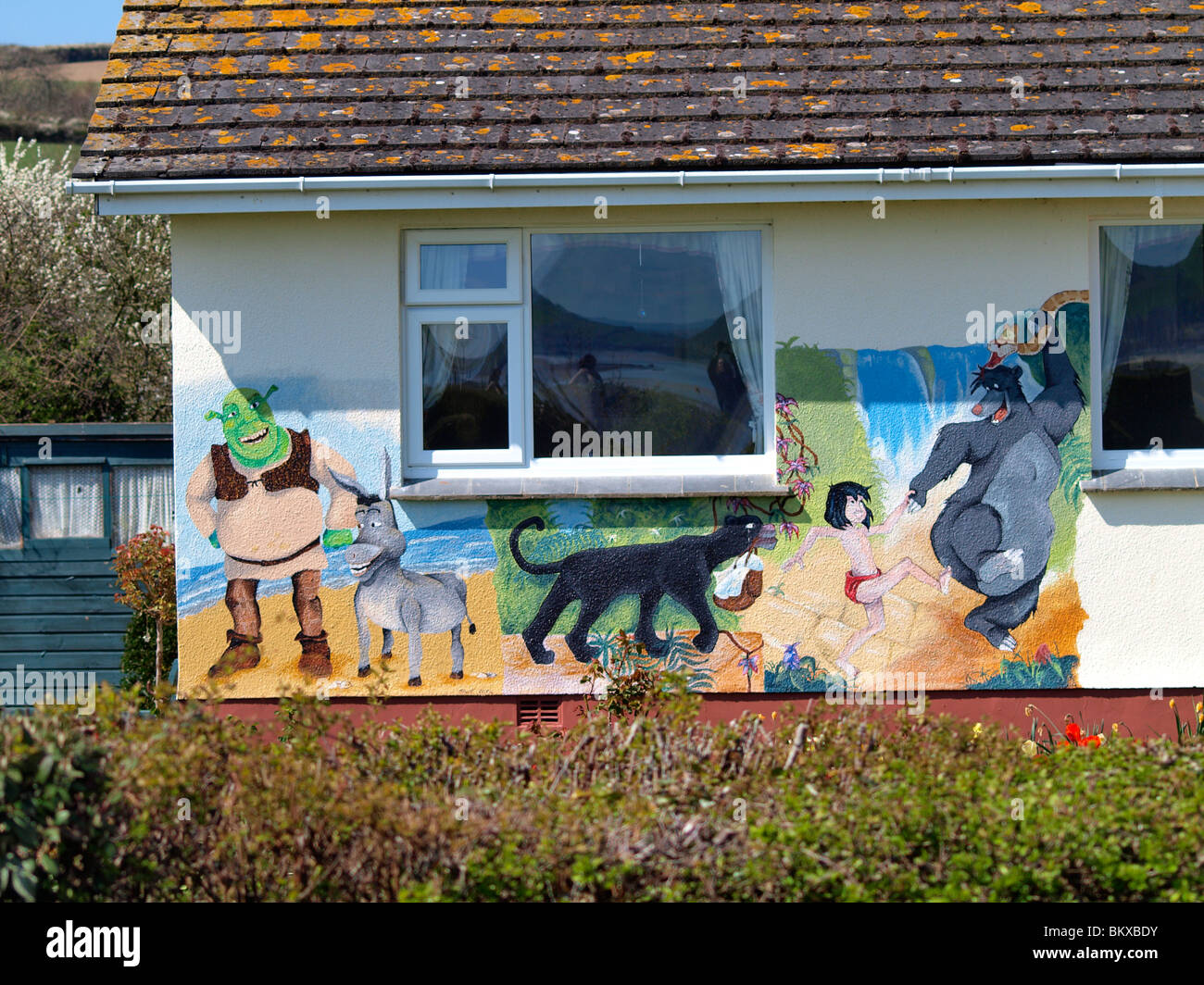 Disney characters painted onto a wall of a house, Padstow, Cornwall, UK Stock Photo