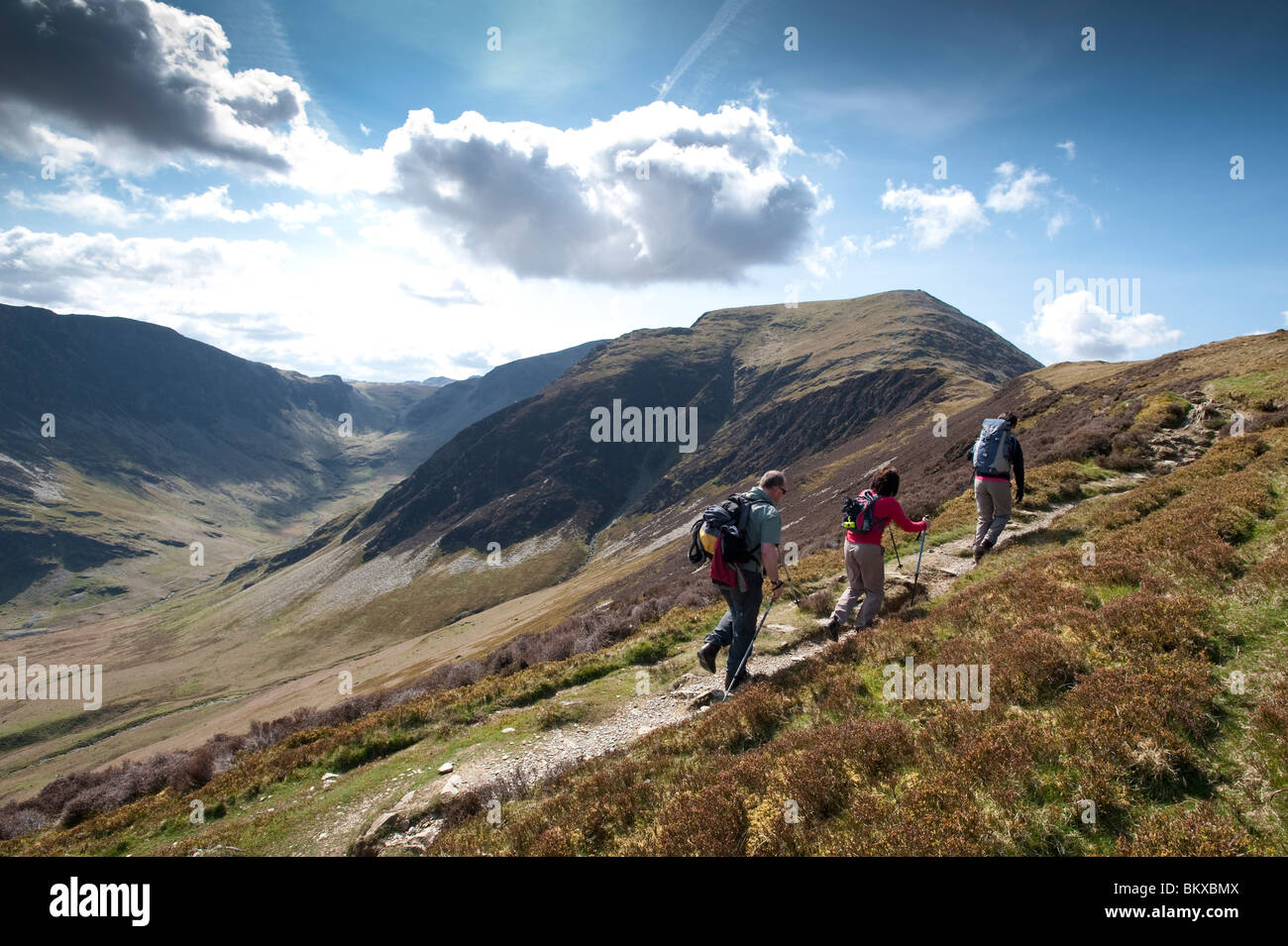 Walkers on a path between between Scope End and Hindscarth in the Newlands Valley in the English Lake District. Stock Photo