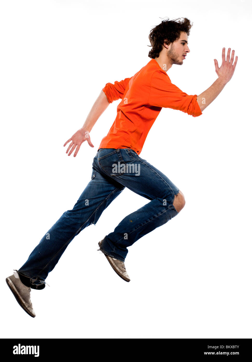 young running caucasian man portrait in studio on white background Stock Photo