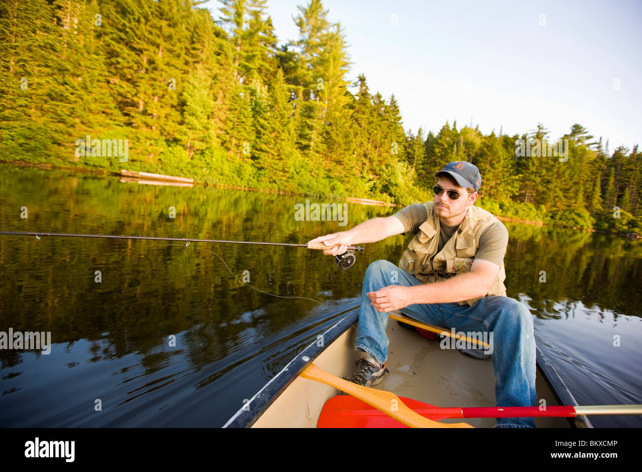 Man fly fishing from canoe on hires stock photography and images Alamy