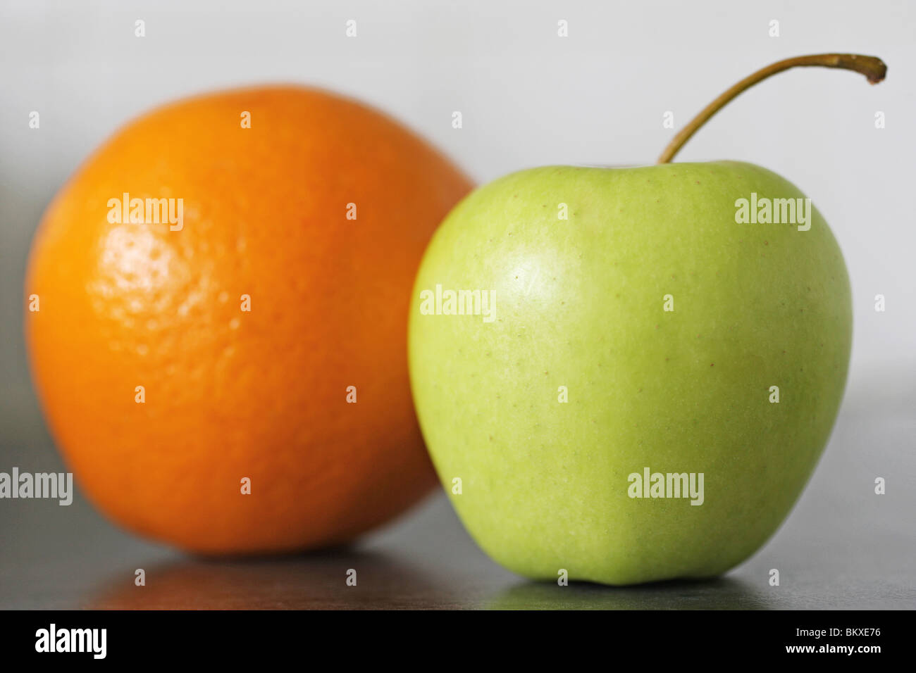 Navel orange and a golden delicious apple Stock Photo