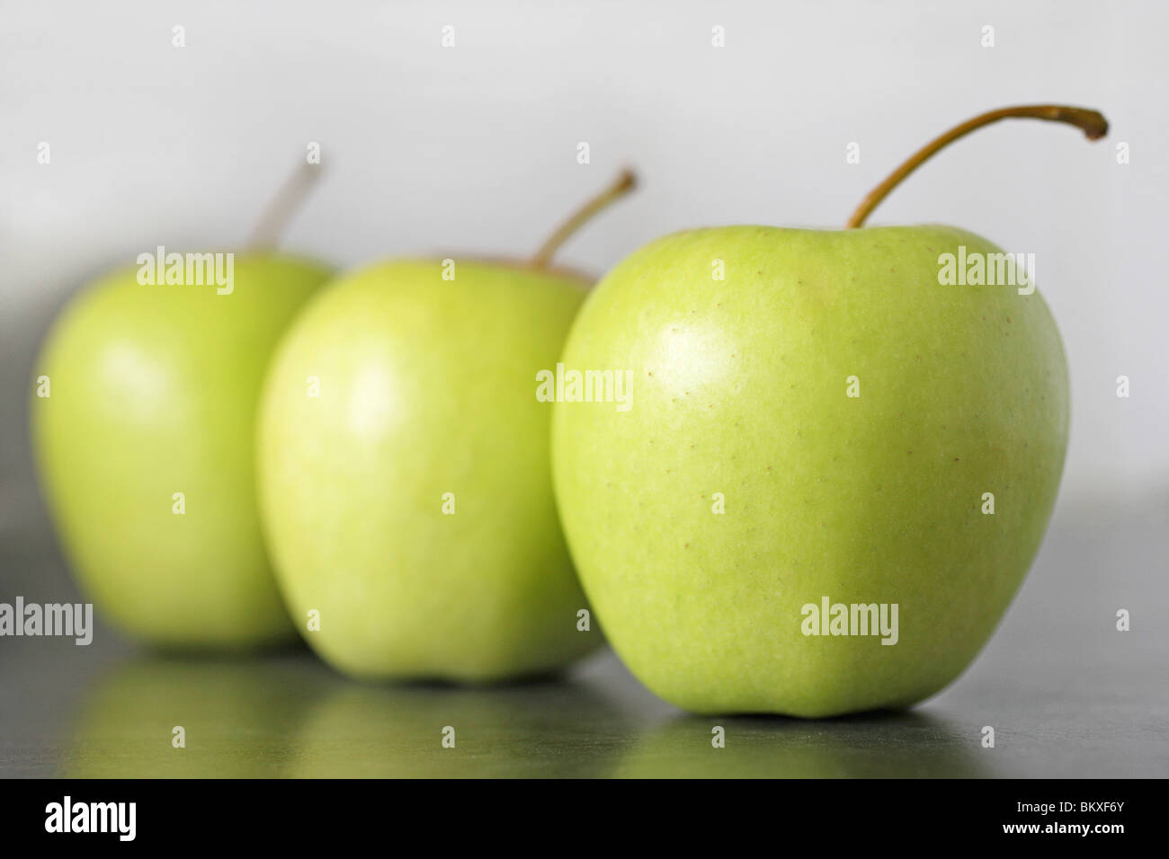 Three golden delicious apples Stock Photo