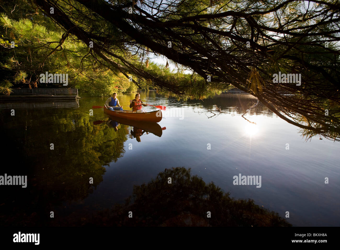 A couple canoeing on Pawtuckaway Lake in New Hampshire's Pawtuckaway