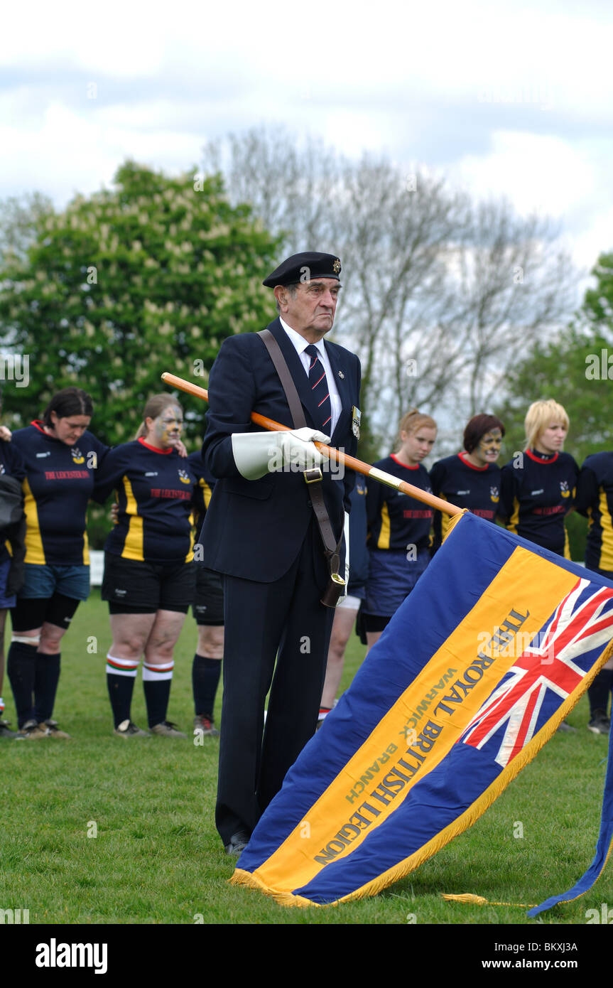 British Legion member lowering the flag at the playing of the Last Post Stock Photo