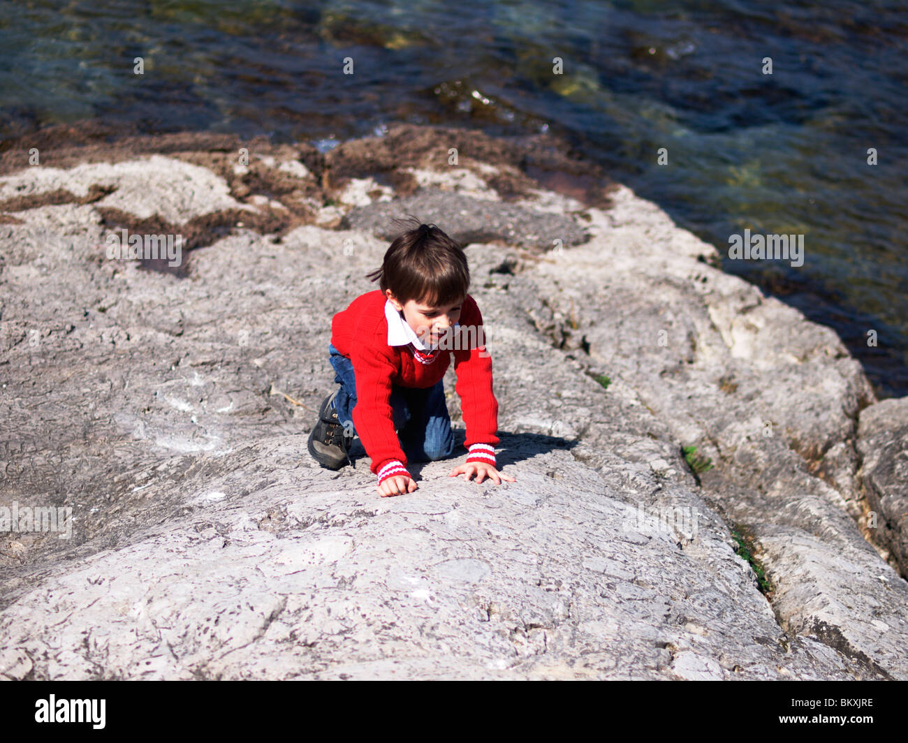 child playing on the rocks Stock Photo - Alamy