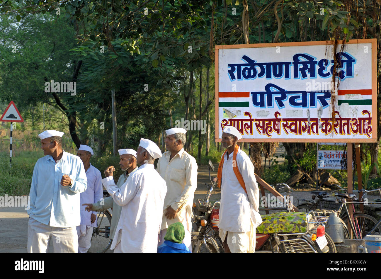 Villagers gathering  near welcome board of the village at Ralegan Siddhi near Pune ; Maharashtra ; India Stock Photo