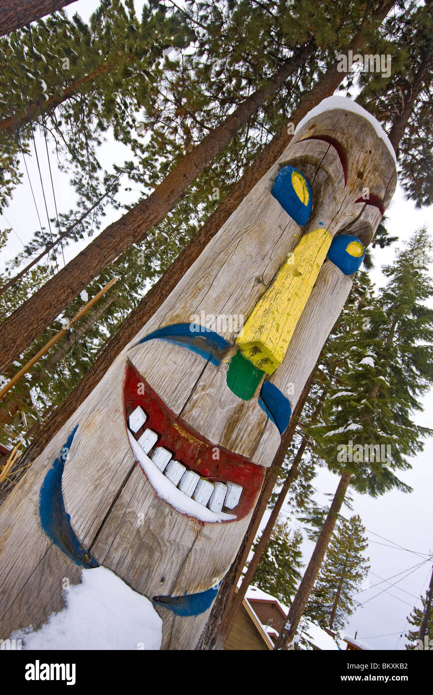 Carved totem pole among homes in Snug Harbor on shore of Lake Tahoe, Nevada, USA. Stock Photo