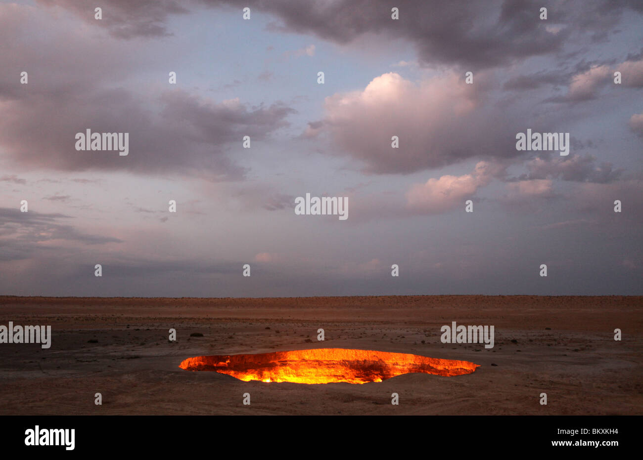 Derweze or Darvaza, aka as the Door to Hell is a huge crater of burning natural gas in the Kara-kum desert in Turkmenistan. Stock Photo