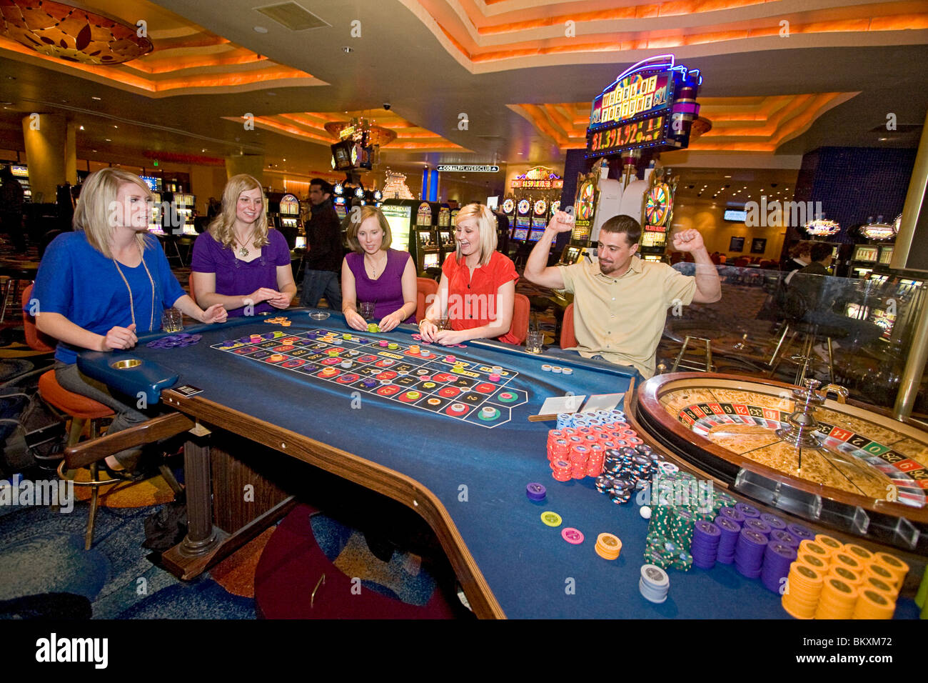 Scene on gaming floor of casino - excited players bet as roulette wheel spins, South Lake Tahoe, Nevada, USA. Stock Photo