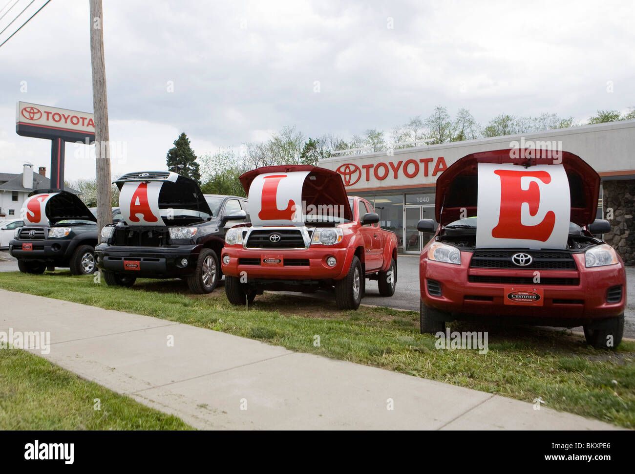 Toyota vehicles on a dealership lot with a "Sale" sign Stock Photo Alamy