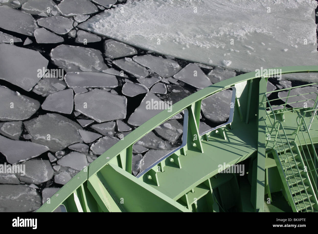 Ferry boat ship cuts through sea ice pack icebreaker Baltic at Helsinki main harbour entrance Winter Finland Stock Photo