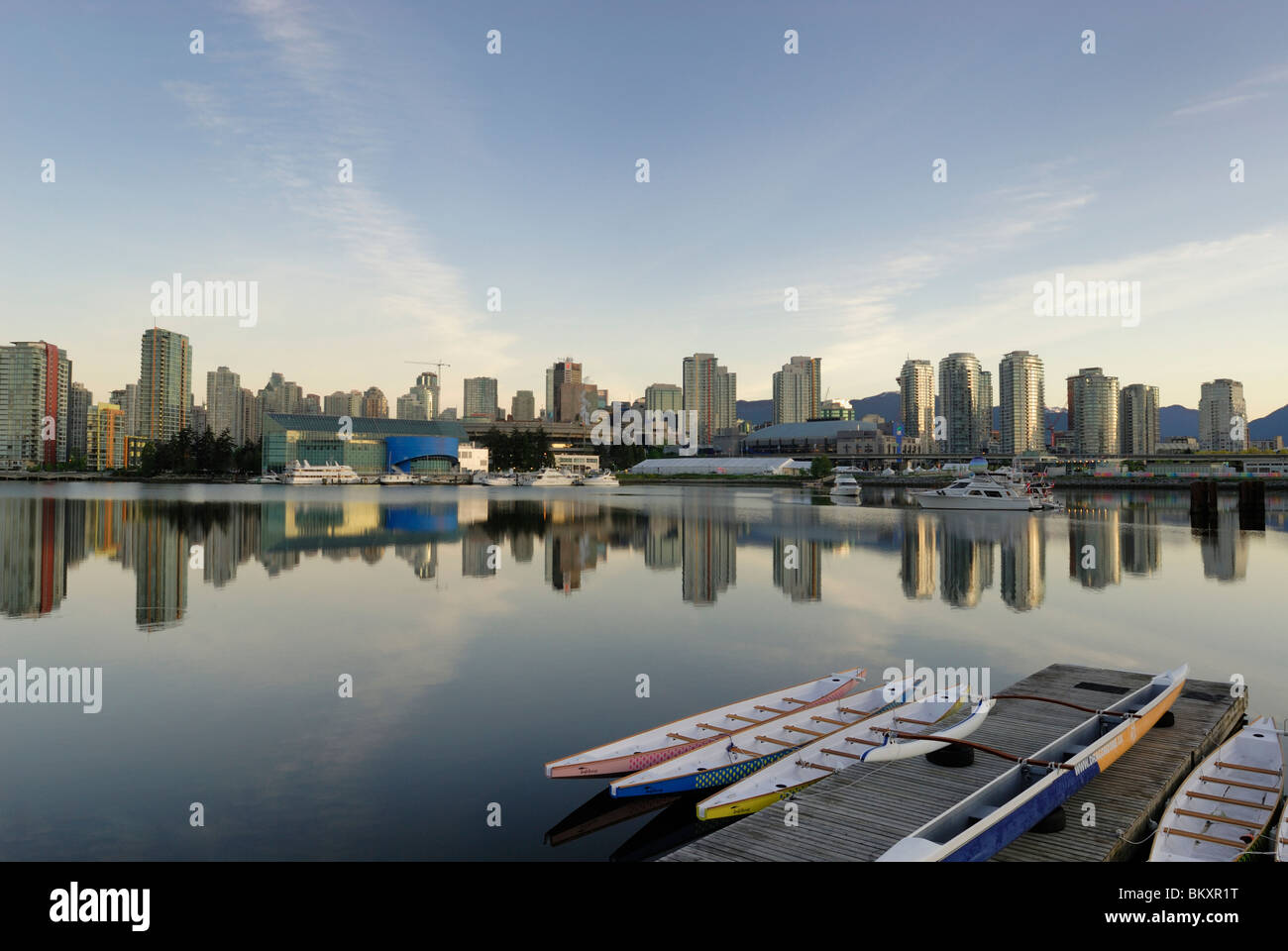Skyline of False Creek in the beautiful City of Vancouver, with resting Dragon Boats in the foreground. Stock Photo
