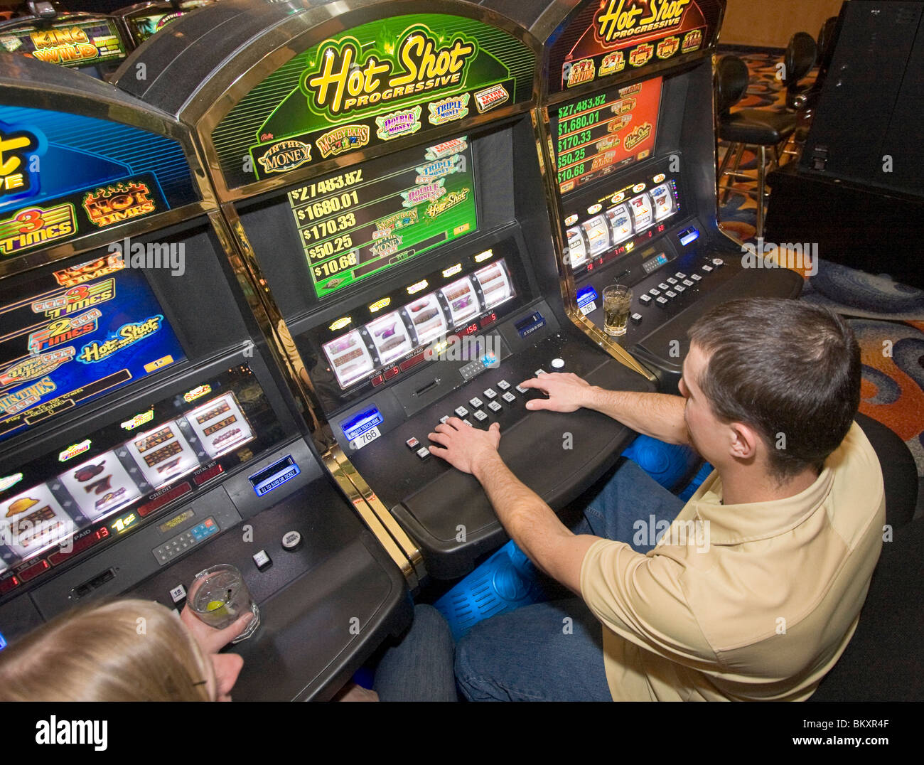 Scene on gaming floor of casino. Man and woman at slot machines in gambling resort, South Lake Tahoe, Nevada, USA. Stock Photo